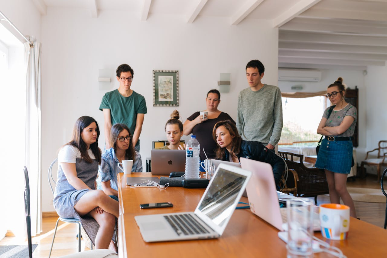 team-04 Group of young professionals engaged in a collaborative meeting in a modern office setting.