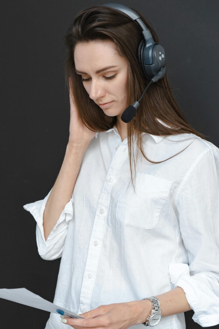 A female call center representative with headset and document working on customer service